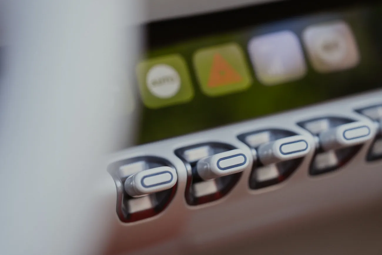 A row of toggle switches below small illuminated buttons