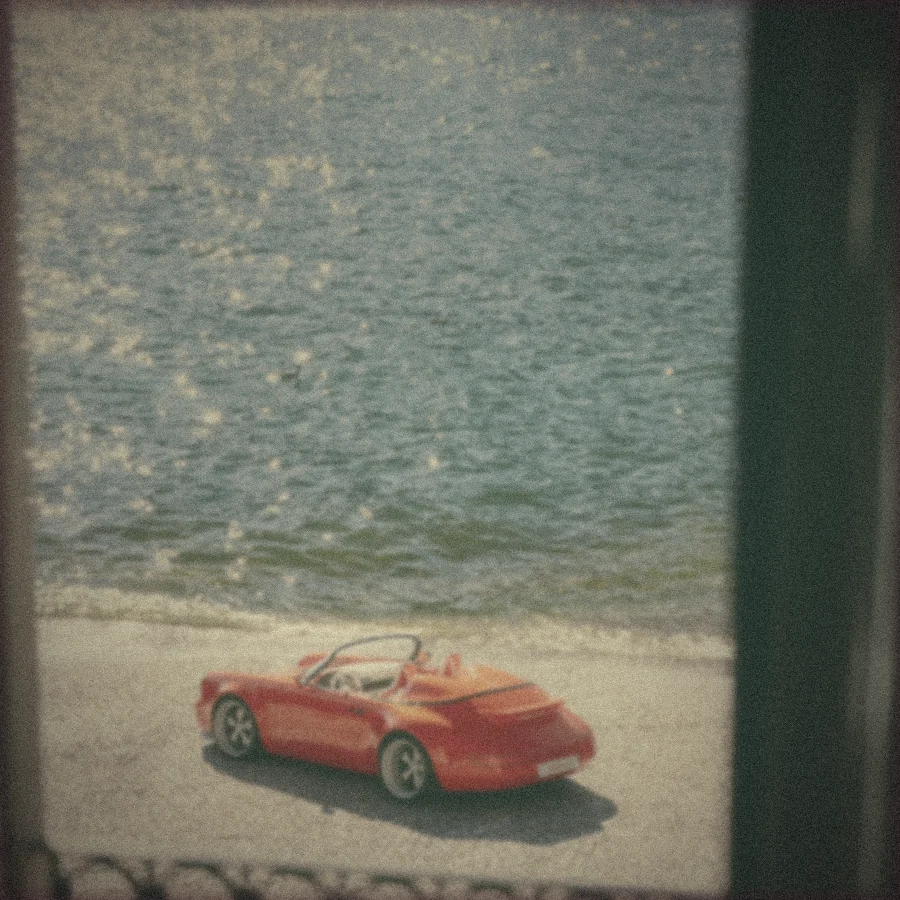 Polaroid: the Funkster parked by the water, seen through a dark window upstairs